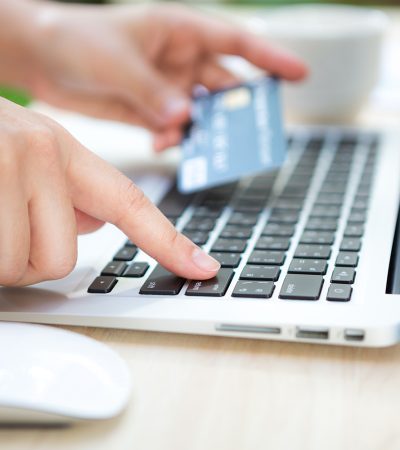 hand with credit card laptop